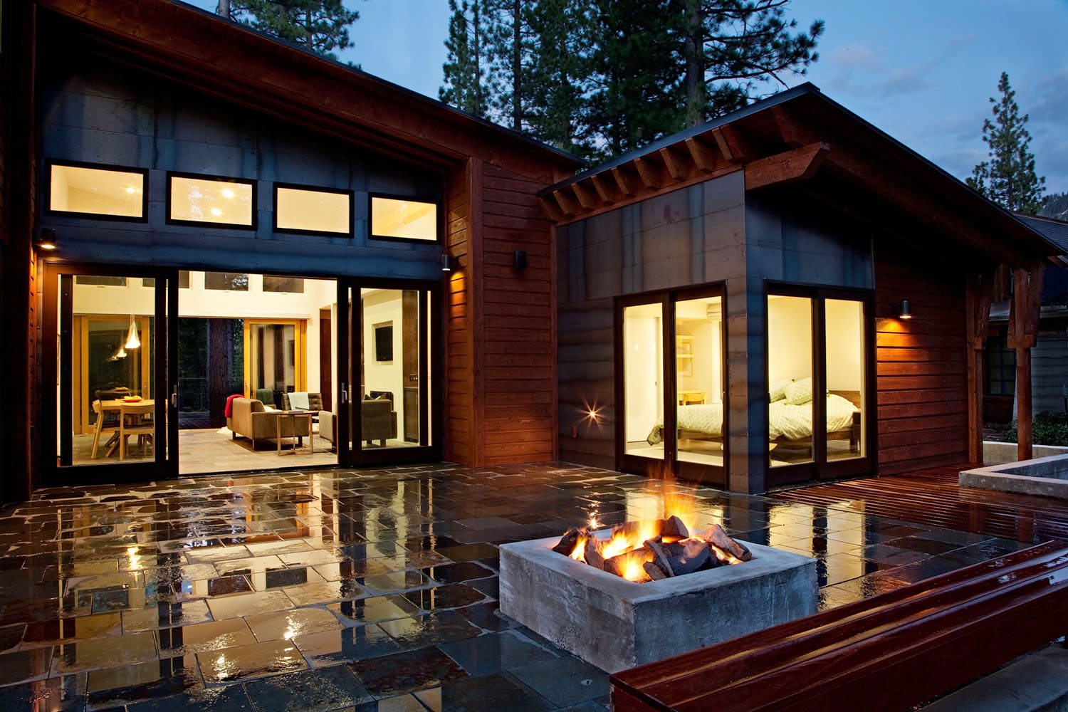 photo of Modern Home on a Mountain With Front Yard Tiling And Outdoor Fireplace